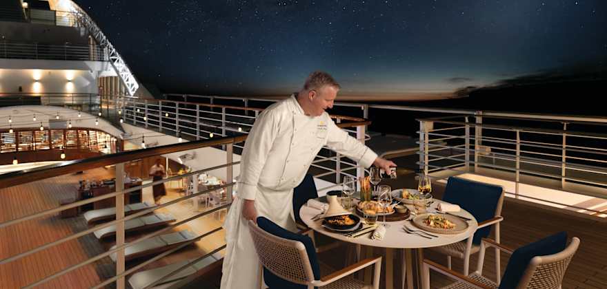 chef setting the table on the deck of a seabourn ship