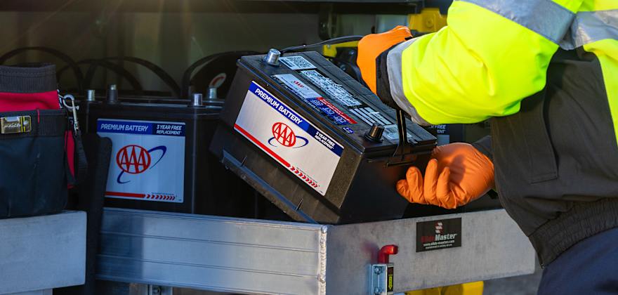 a AAA technician installs a battery