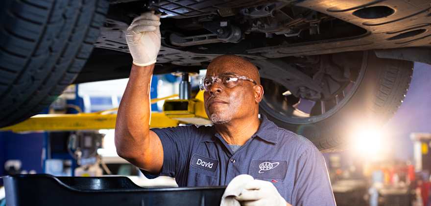 A mechanic works on a vehicle