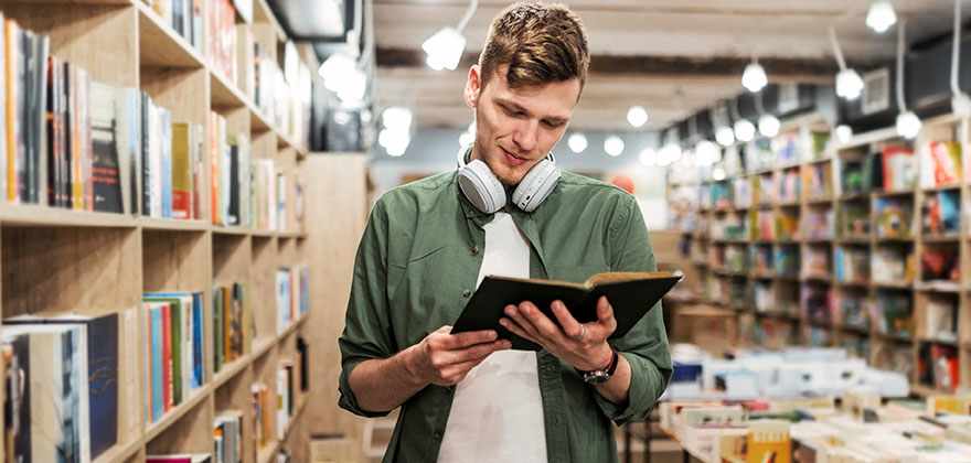 Person holding a book in a book store
