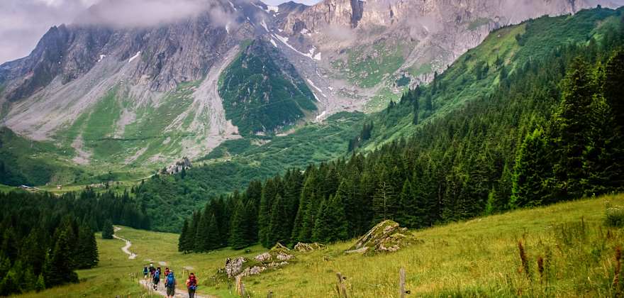 people hiking near mountains in france
