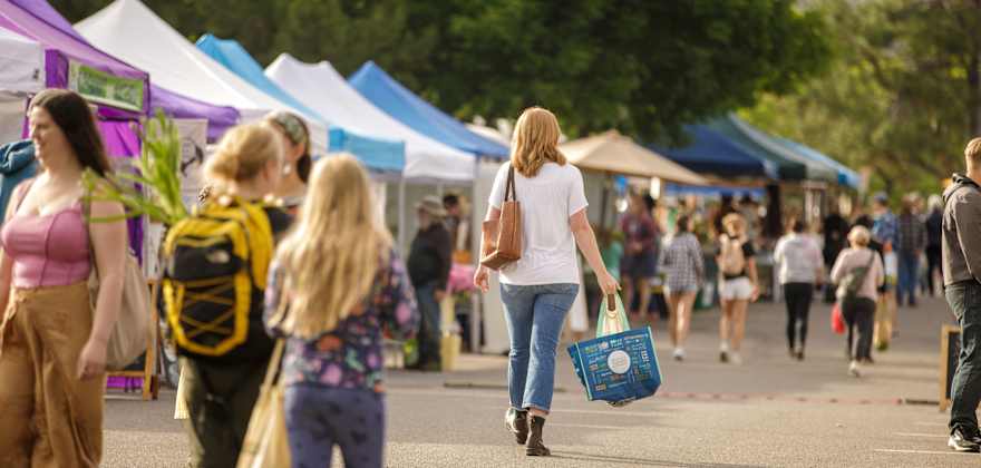 People walk the Clark Fork River Market in Missoula, Montana.