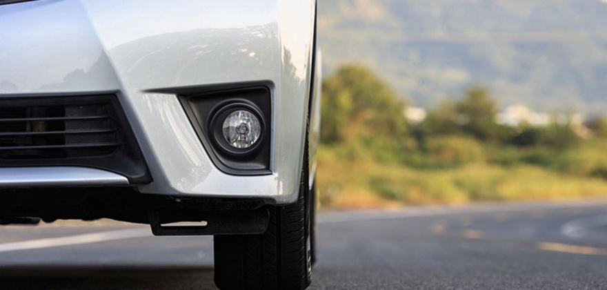 A white car owned by a AAA Member goes down the windy road