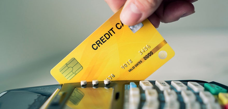 a cashier swipes a credit card
