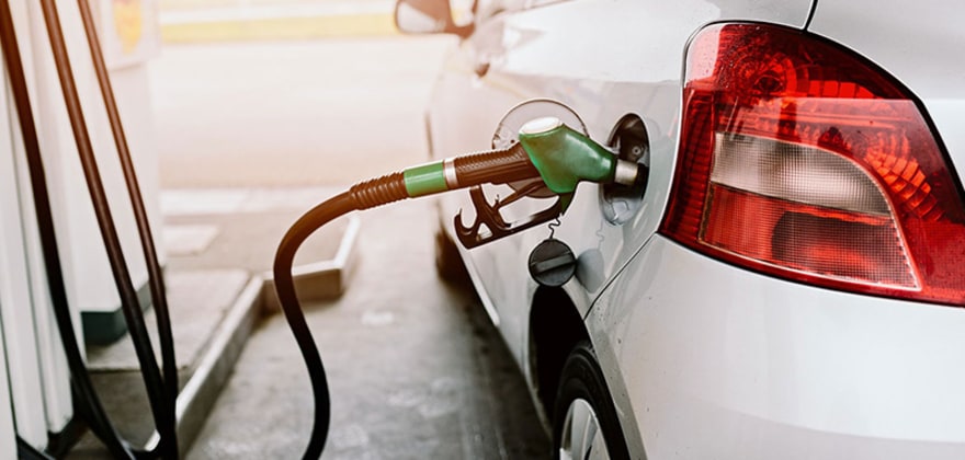 a car fills up at the gas pump