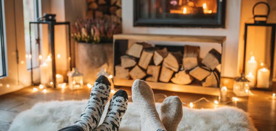 AAA Members sitting in front of a fireplace in winter
