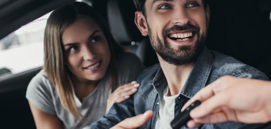 a couple gets the key to a new car 