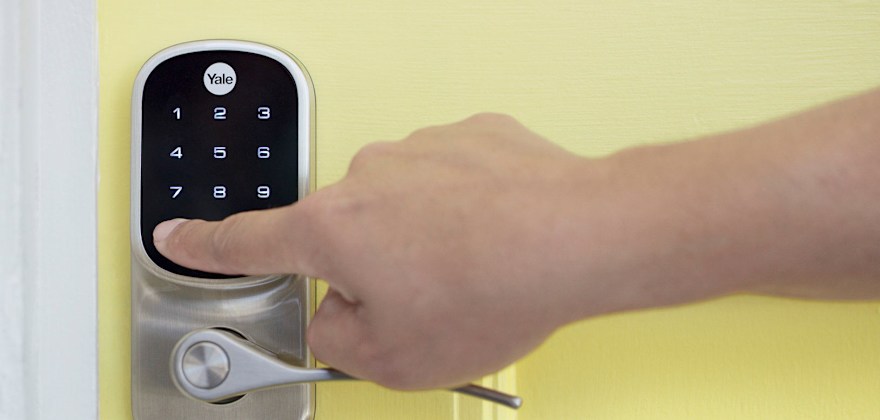 Entering keypad code on security door lock