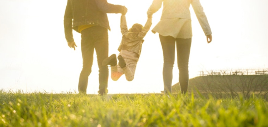 Couple playing with their small child in a park