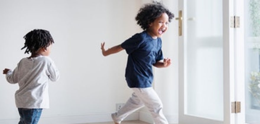 girls run through a new condo townhouse with AAA condominium insurance