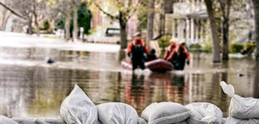men rescue a homeowner with flood insurance from AAA during a flooding event