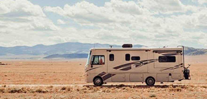 Motorhome RV covered by AAA Insurance driving across the desert