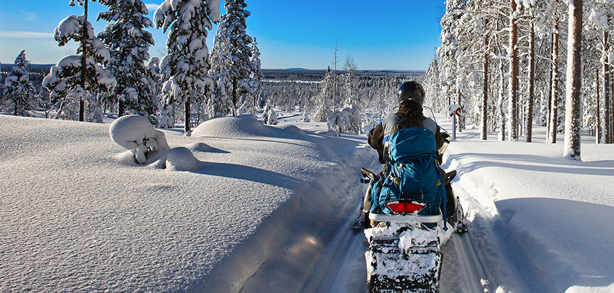 a person on a snowmobile covered with snowmobile insurance through AAA