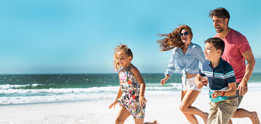 Family running on the beach