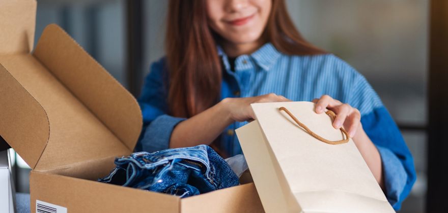 A woman opens an online shopping purchase.