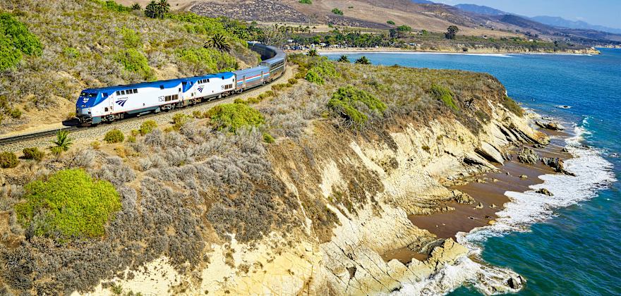 Amtrak train winds along the coast in California.