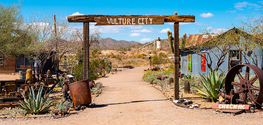 A wooden sign over the road in Vulture City ghost town in Maricopa County, Arizona.