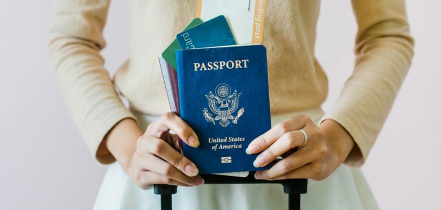 Someone with a passport gets ready to board a plane