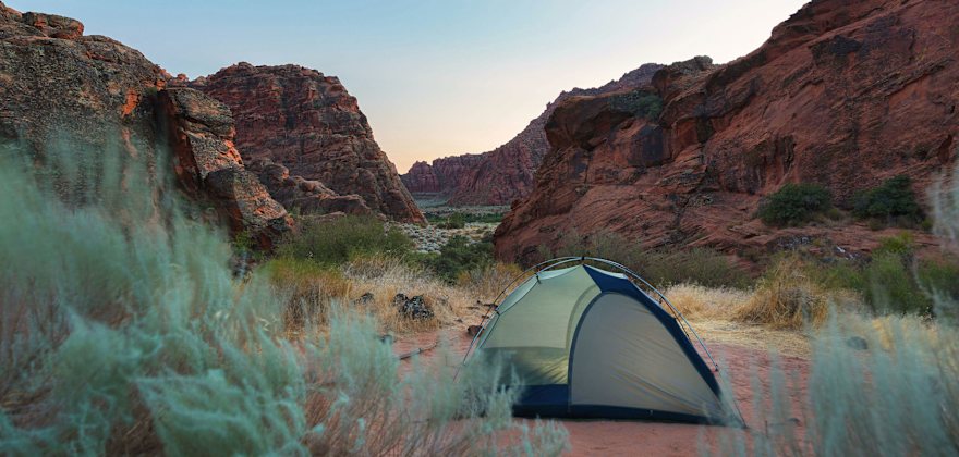 Sunset behind a tent at a campsite in Snow Canyon State Park in Utah.