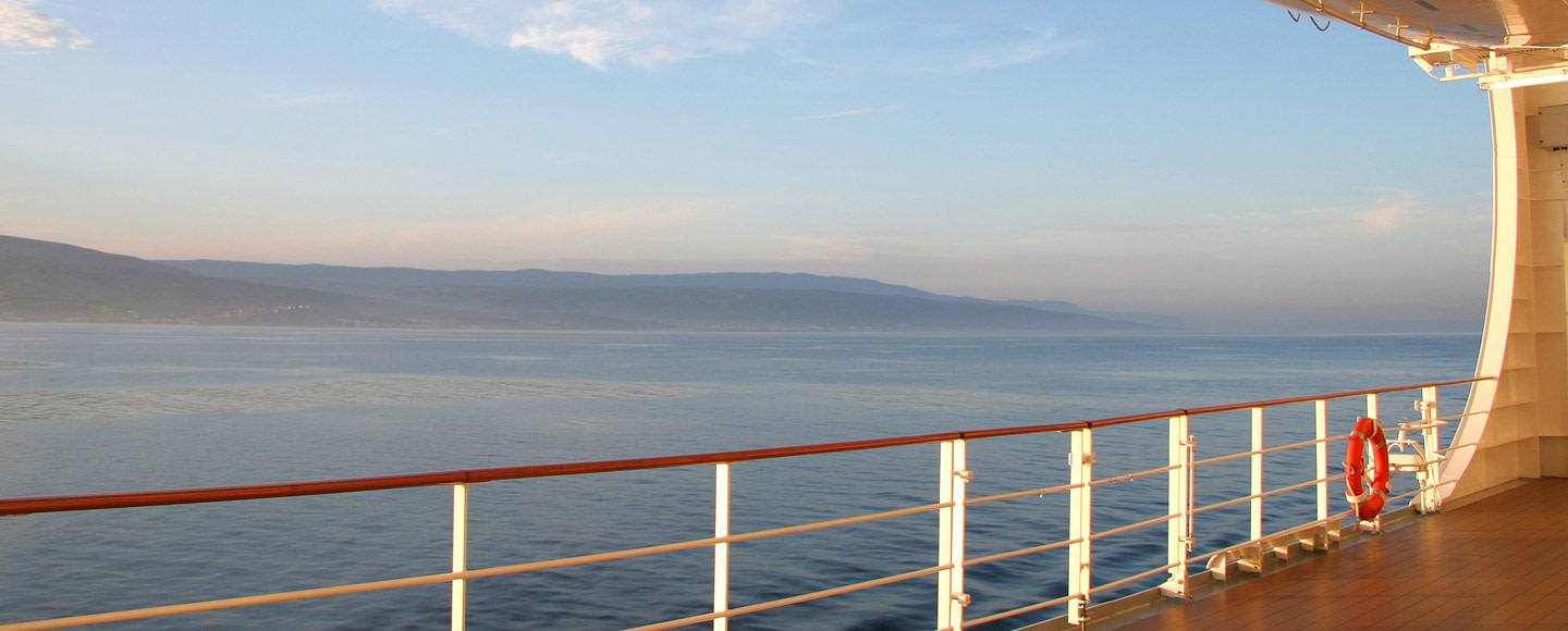 deck of cruise ship with coast in distance