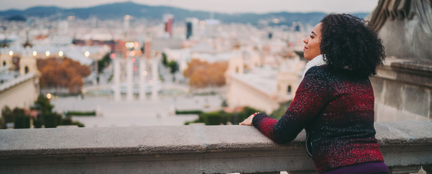 woman on balcony overlooking barcelona