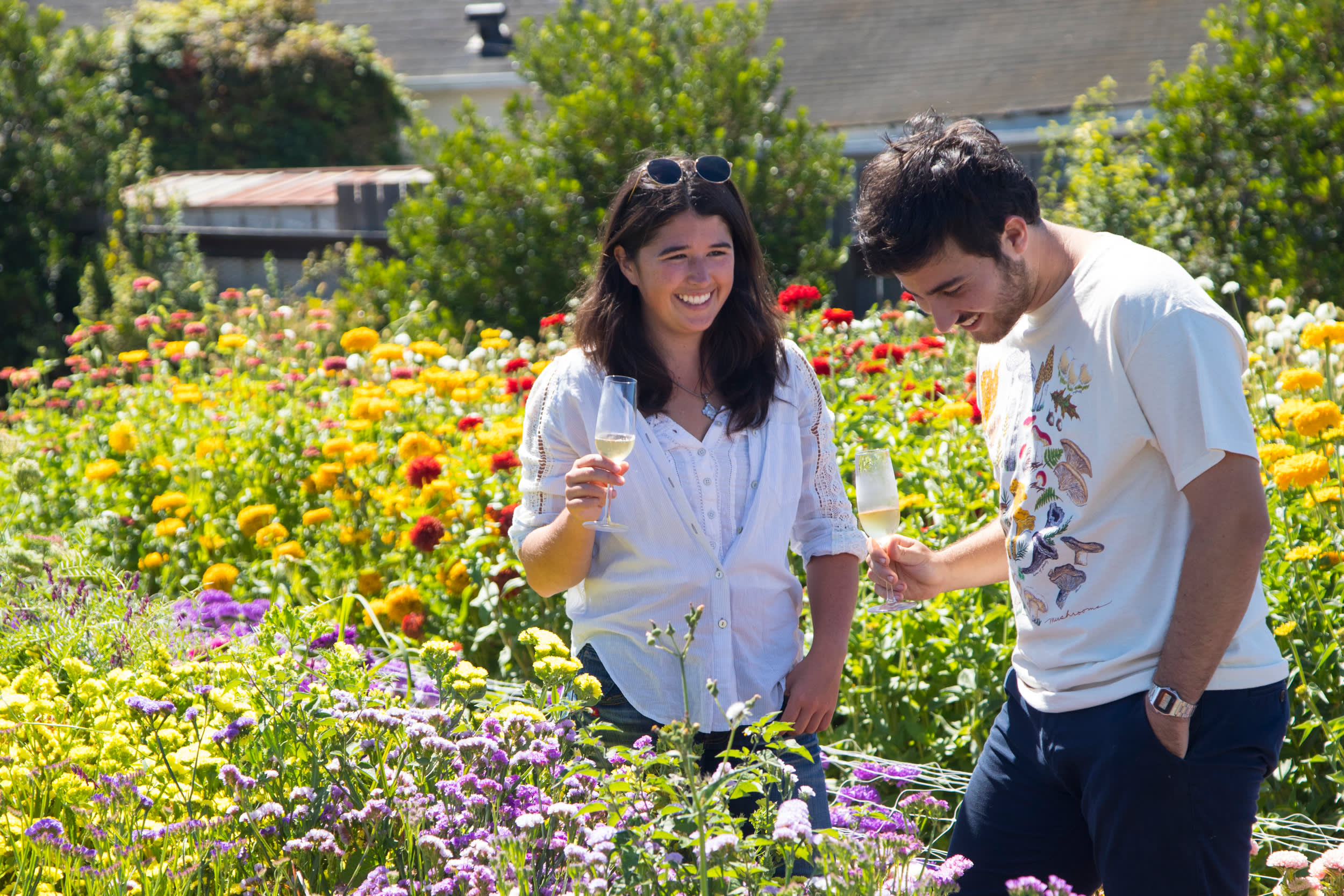 a couple enjoys a mead tasting out in Heidrun Meadery's flower garden 