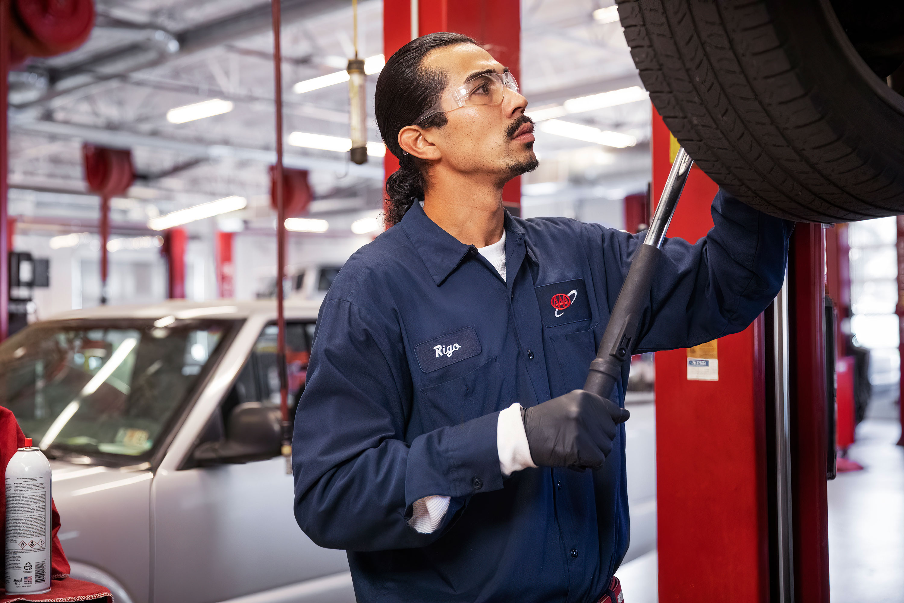 A technician removes a tire inside a AAA Auto Repair Center.