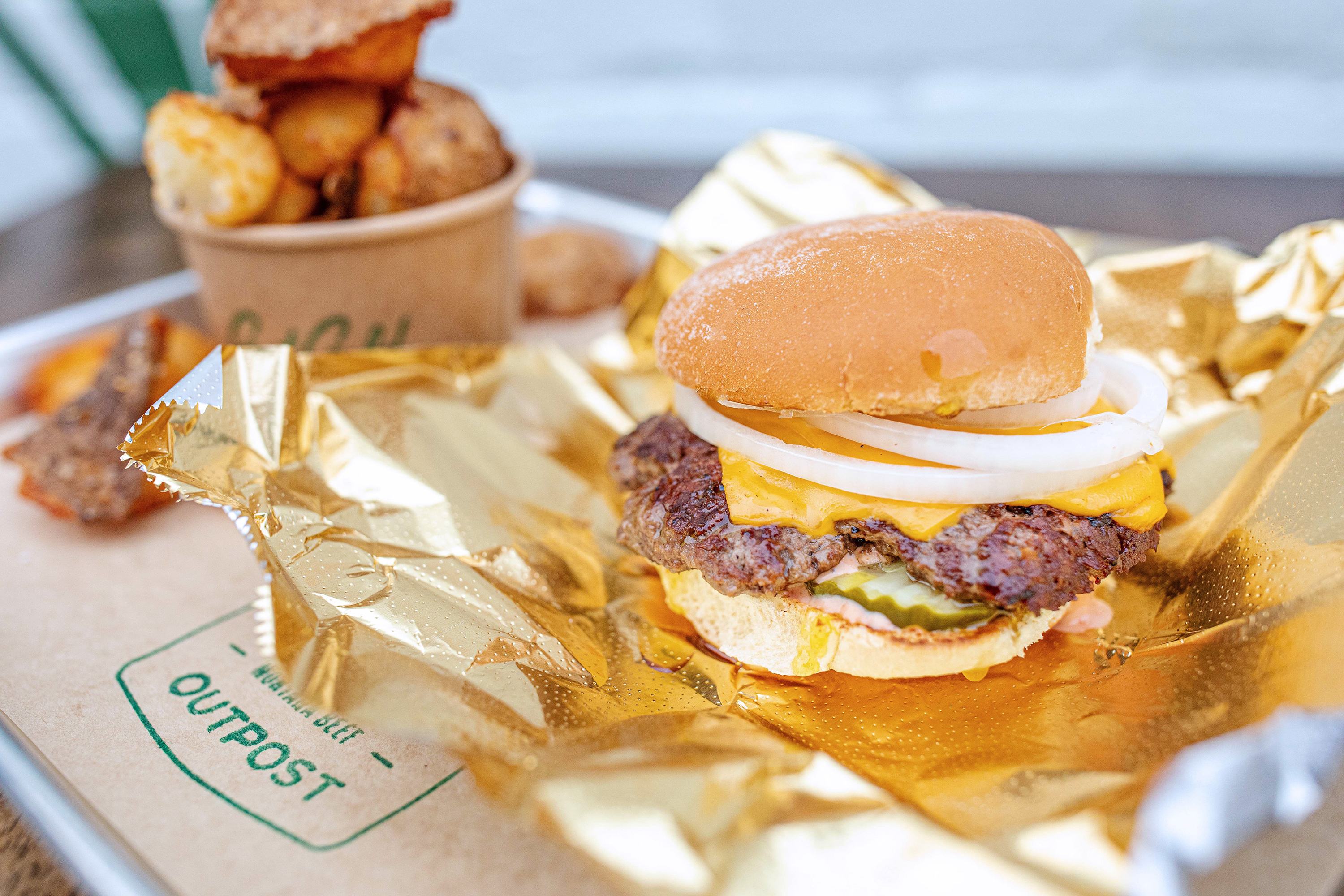 Classic single cheeseburger combo on a tray at Old Salt Outpost.