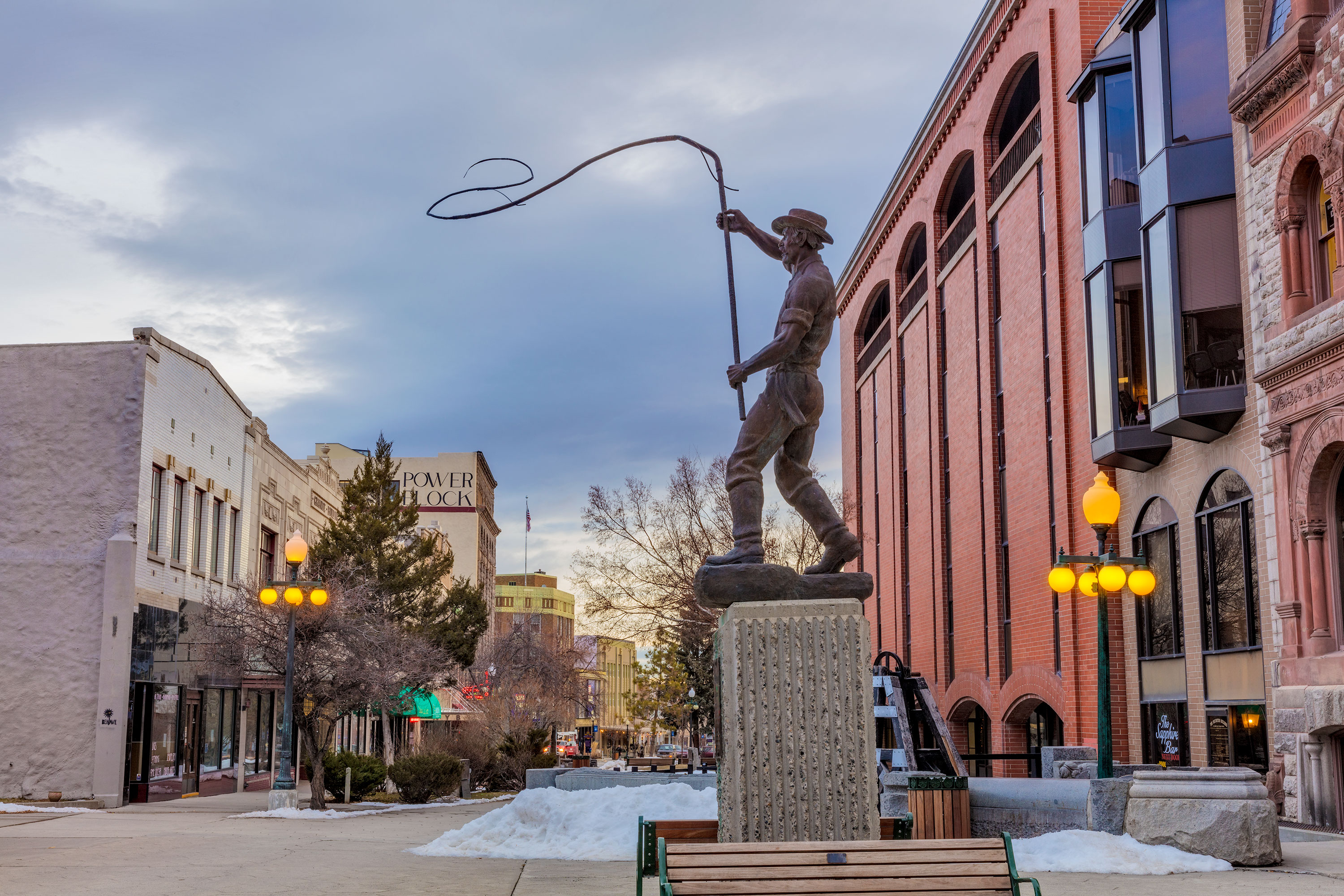 Bullwhacker statue in historic Last Chance Gulch in downtown Helena, Montana, on a cloudy day.