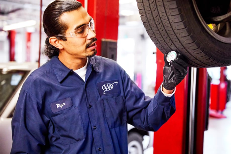 AAA auto repair mechanic inspects car