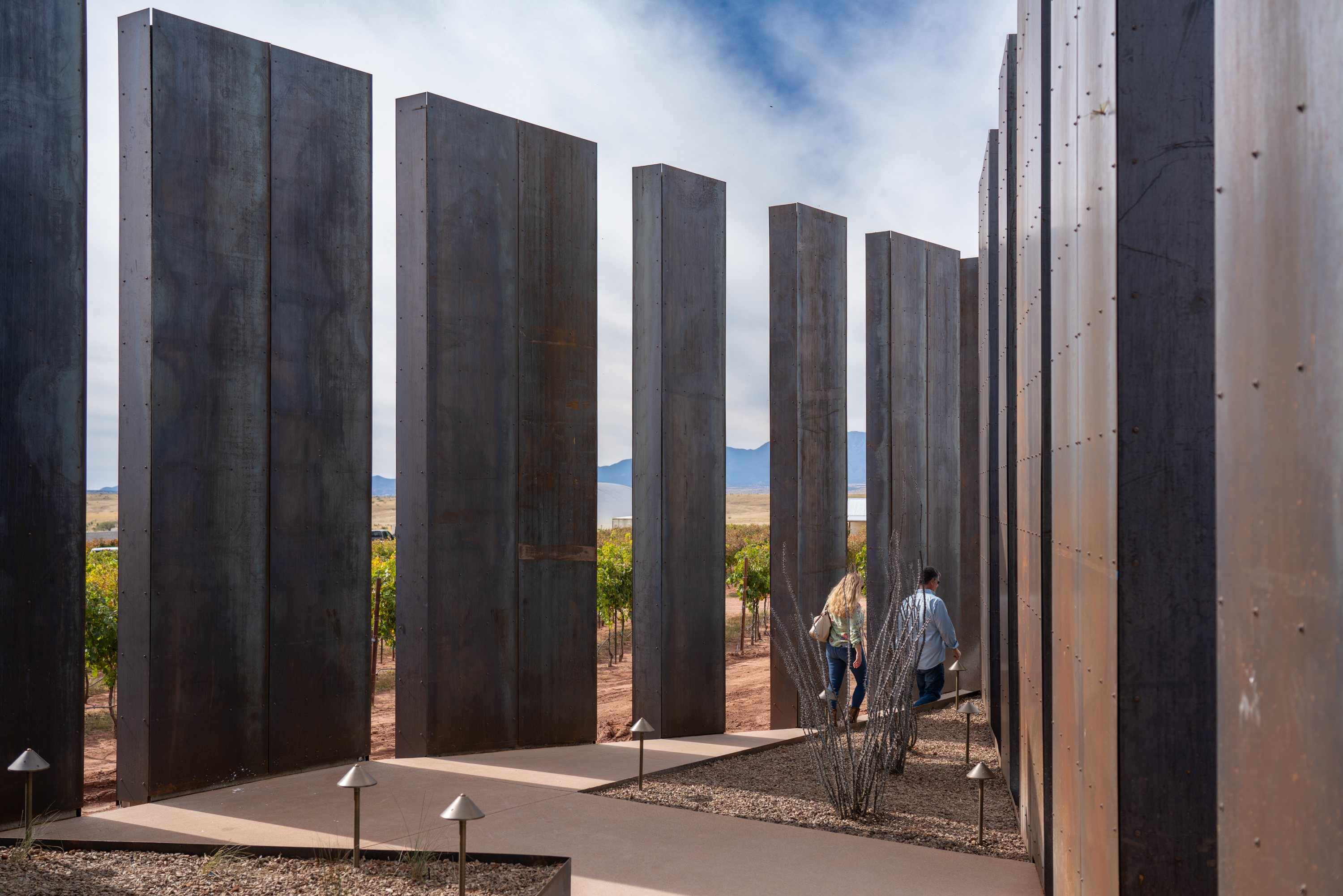 A couple walk into the Los Milics Vineyards’ tasting room in Elgin, Arizona.