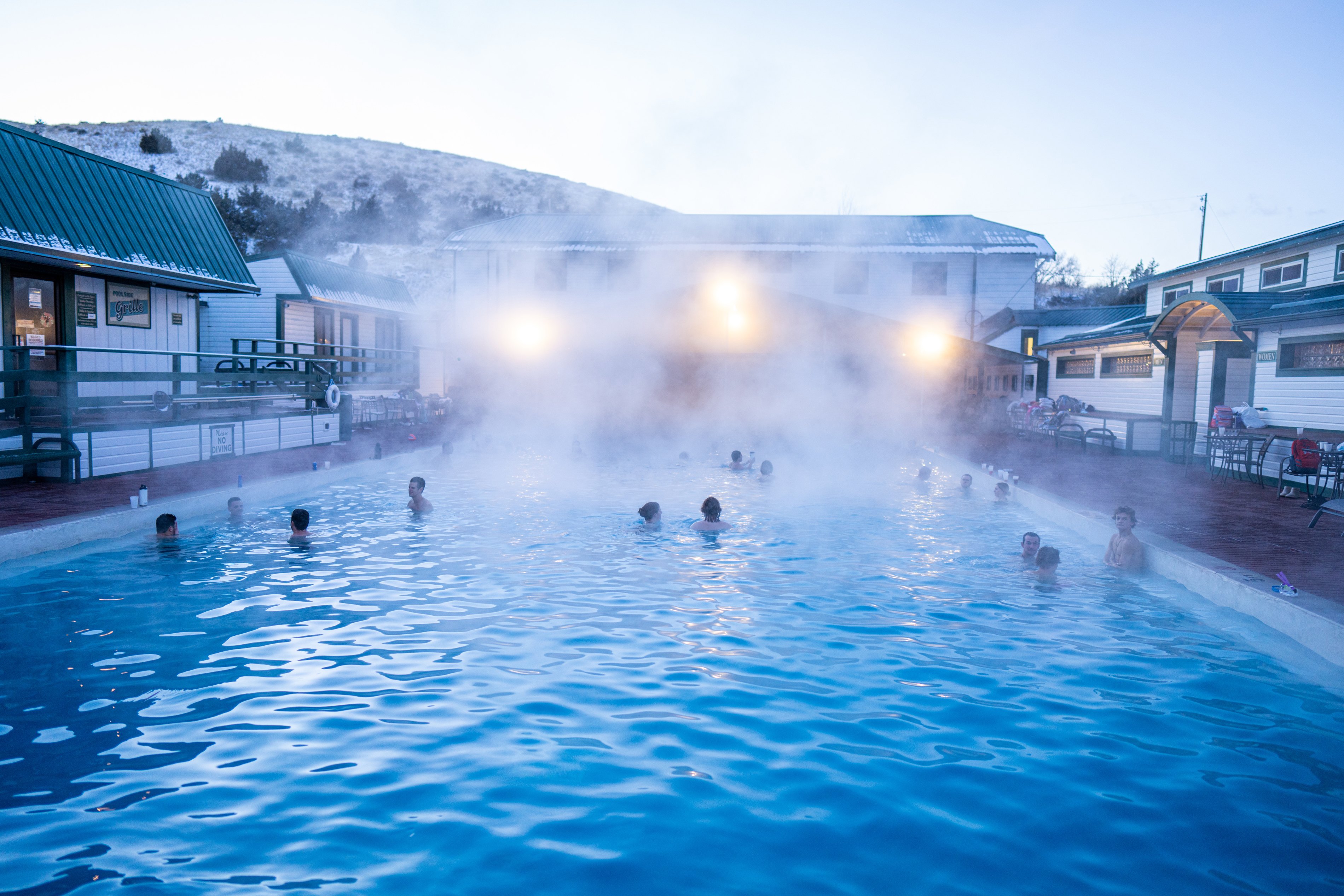 Visitors soak in Chico Hot Springs near Pray, Montana at dusk.