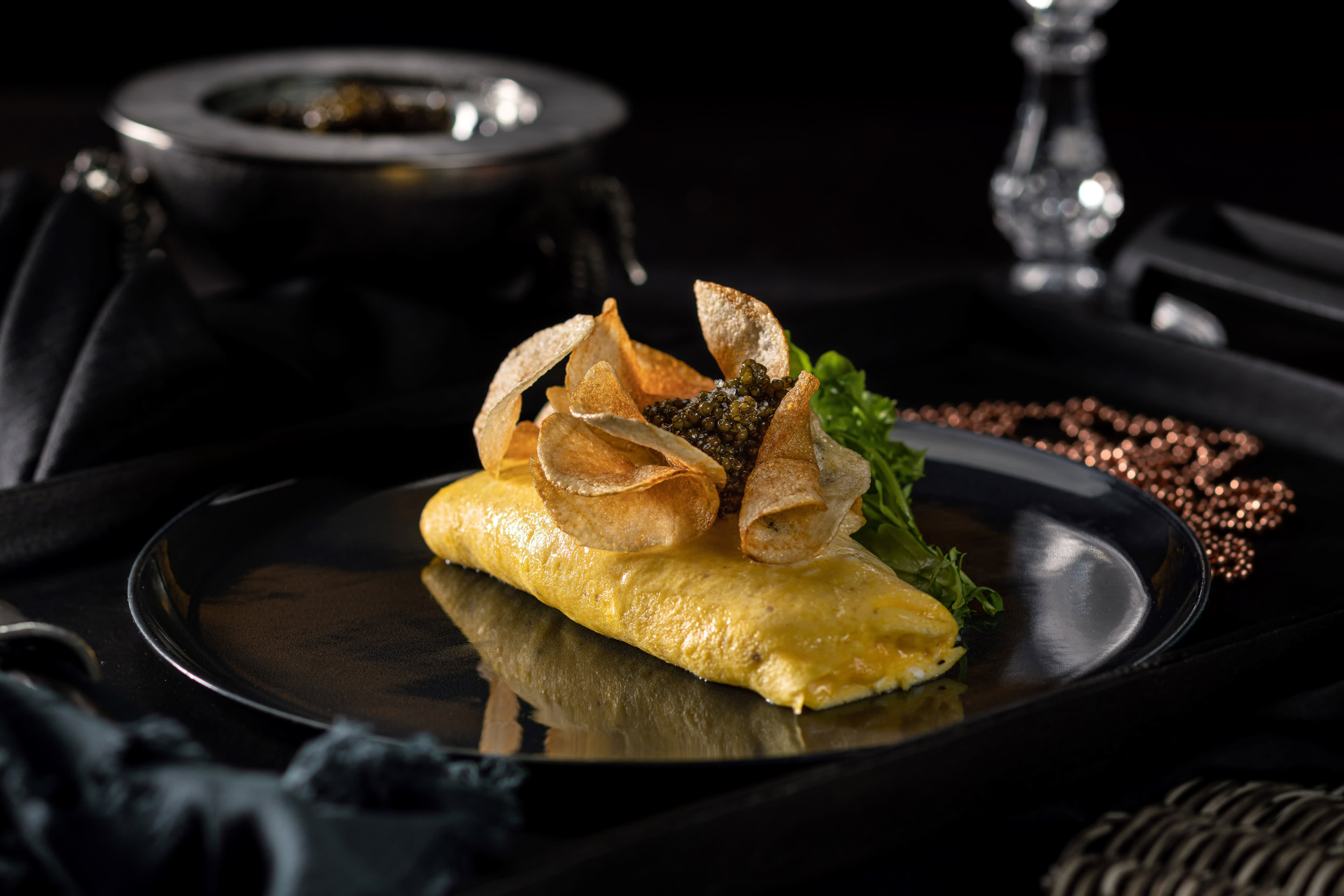 Omelette on a black plate from Cathedrale at ARIA.