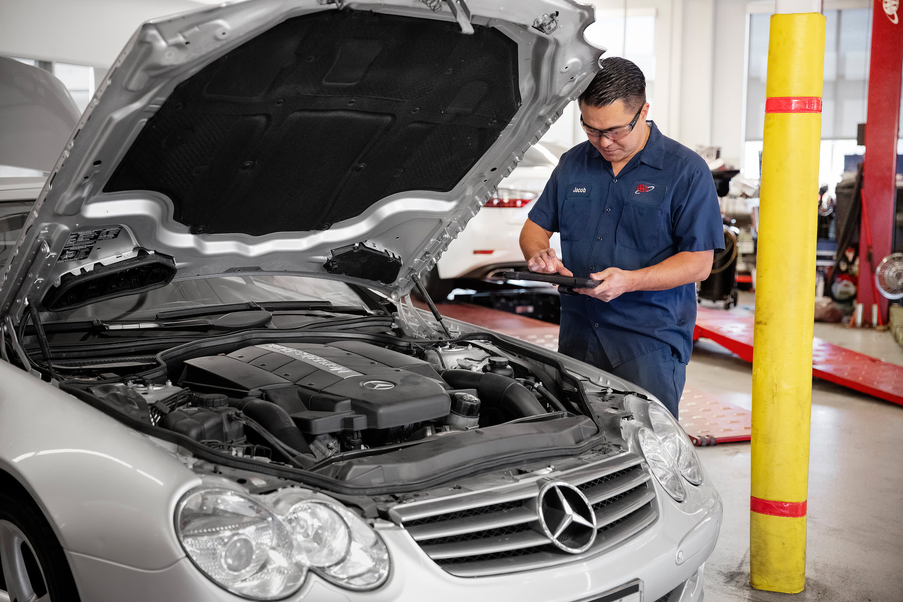 A AAA Auto Repair mechanic completes a full inspection of a Mercedes.